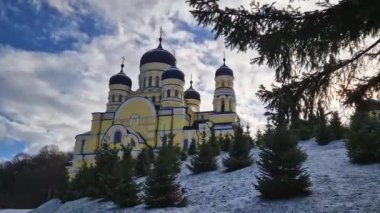 Hancu Monastery outdoors winter view. Traditional Christian Orthodox church located in the middle of the snowy woods in Republic of Moldova. Eastern Europe basilica traditional architecture style
