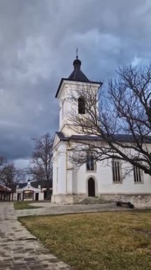 Capriana Monastery yard view with the bell tower in the foreground. Traditional Christian Orthodox church located in Republic of Moldova. Eastern Europe basilica traditional architecture style