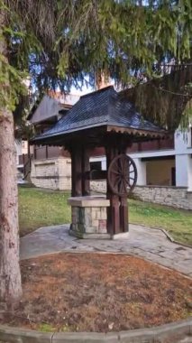 Traditional old well made of wood and stone, in the Capriana monastery courtyard, Moldova