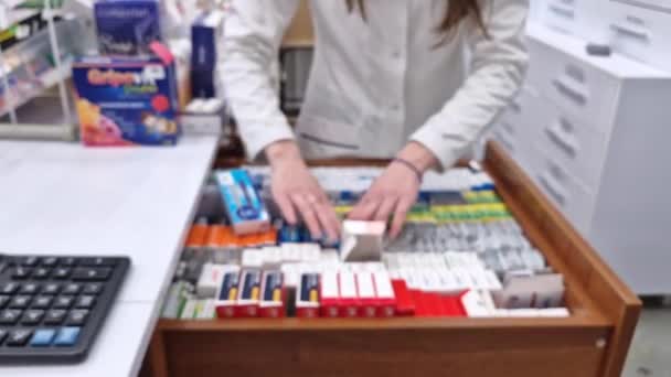 Вид Дефокус Всередині Аптеки Жіночим Фармацевтом Зберігає Ліки Всередині Ящиків — стокове відео