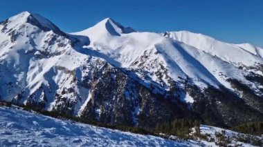 Pirin dağlarının üstündeki kayalık tepeleri karla kaplı hava manzarası. Bulgaristan 'daki Bansko kayak merkezinde kış manzarası