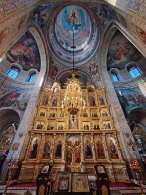 Capriana Manastırı Moldova 'da bulunan geleneksel Hıristiyan Ortodoks kilisesine ev sahipliği yapıyor. İlahi ayin sırasında sunakta dua eden bir keşişle büyük yaldızlı bir avizenin altında