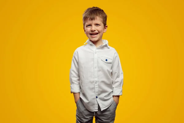 Cute Atrakcyjny Mały Chłopiec Modnej Białej Koszuli Trzymając Ręce Kieszeniach — Zdjęcie stockowe