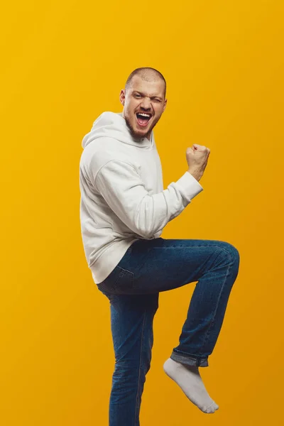 Vertical Photo Young Man Celebrating Success Wearing White Hoodie Jeans — Stock Photo, Image