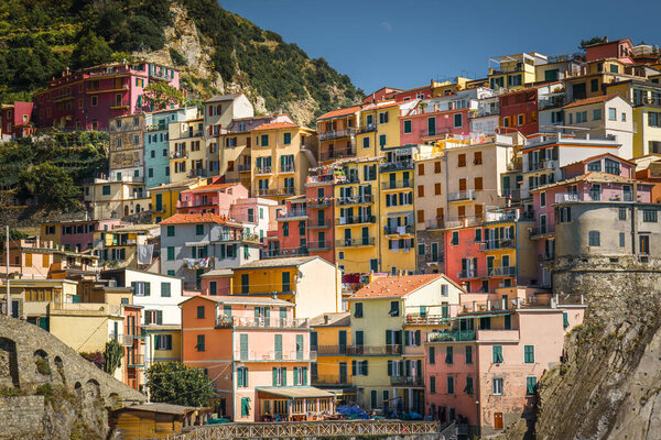 Mediterranean Italian town. Colorful houses. Hills and vineyards in the background. Real estate.