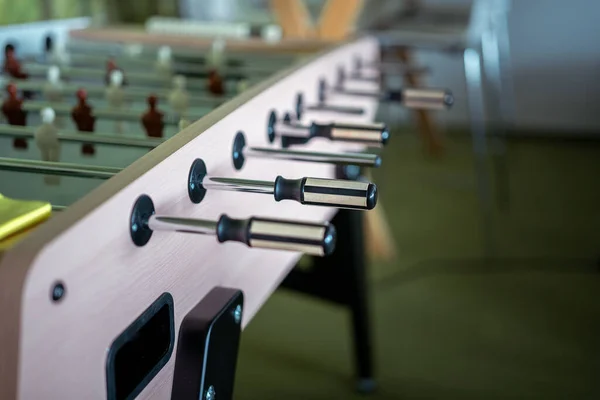 Foosball table. Office game. Game  players. Play room interior.