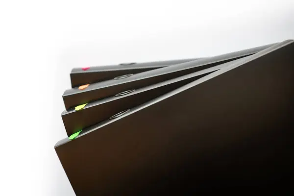 Folders with documents. Binders with contracts and bills stacked. Black folders on isolated white background.
