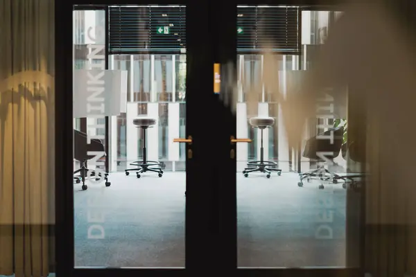 Modern office spaces. Corporation, conference rooms. View through the office door to the conference room. Start new business.