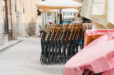Closed restaurant in the old market square. Folding restaurant chairs.