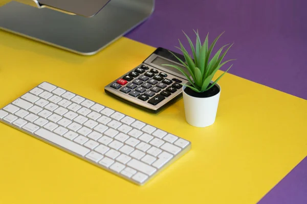 Colorful table with keyboard and calculator. Isometric view.
