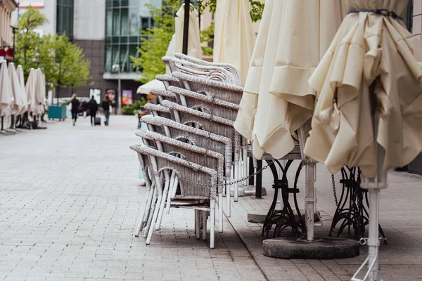 Folded chairs in front of a closed restaurant. European city restaurant.