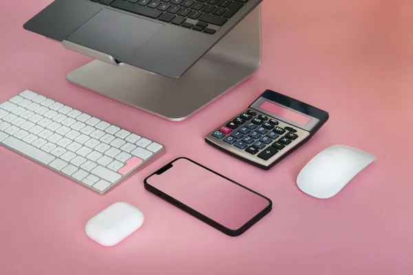 Electronic office devices. Clean empty screen mockup. Peach color background. Smartphone screen. Calculator mouse and keyboard. Pink color details.