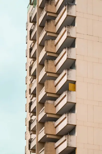 Concrete residential skyscraper. Brutal concrete architecure. Real estate. Geometric shape.