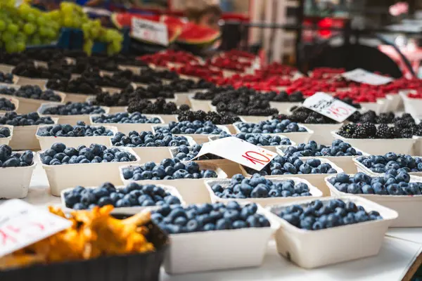 stock image Fruit packages city market. Blueberries, strawberries, mushrooms and blackberries.