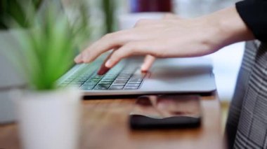 Laptop klavye ev ofisini rahatlatmak iş blogcusu bilgisayar klavyesine yazı yazmak ev oturma odasındaki yazılım mühendisi yeşil bitkiler ve akıllı telefon şirketlerinin ahşap masasını kapatmak