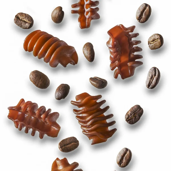 Coffee pasta and coffee beans in motion on a white background