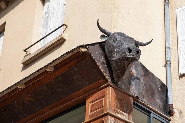 Metal ox head on a store wall