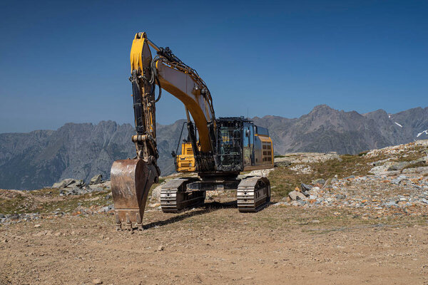 Excavator in the French Alps in summer