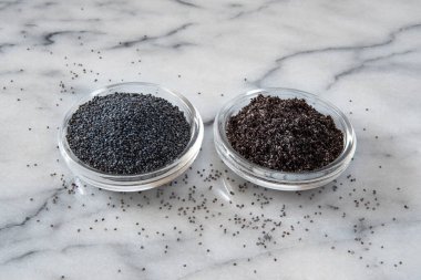 Beyaz mermer bir arka planda kurutulmuş haşhaş tohumu ve toz yakın plan