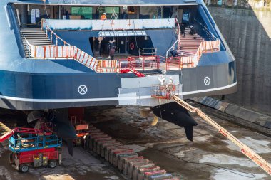 Ship in dry dock in a port for repairs clipart