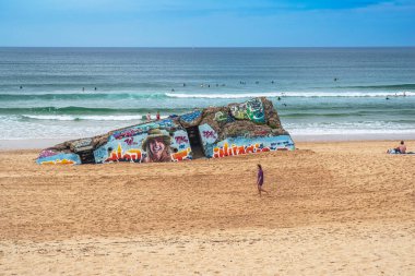 Painted bunker and walker on Capbreton beach in the Landes region of France clipart