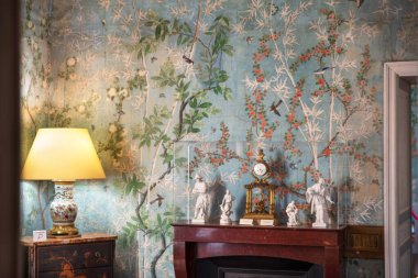 Wall decoration with antique wallpaper and furniture in the Chteau de Maintenon in France clipart