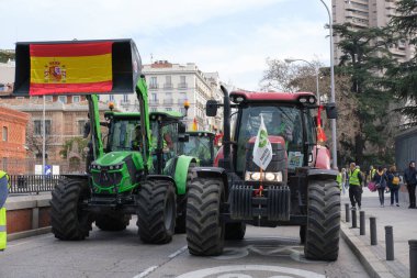 Protestocular, çiftçilerin 21 Şubat 2024 'te Madrid' deki Avrupa tarım politikasını kınamak için düzenledikleri protesto sırasında Puerta de Alcal önünde traktörlerle geliyorlar. İspanya
