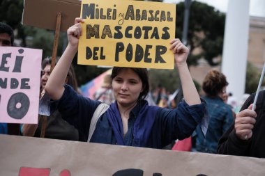 Several people protest during a demonstration against Milei's visit to Spain in the Plaza de Colon, May 19, 2024, in Madrid, Spain. clipart