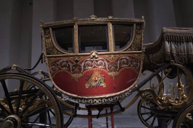 View of the exhibition of In Motion. Vehicles and carriages of National Heritage in Gallery Of The Royal Collections museum on June 28, 2023 in Madrid, Spain clipart