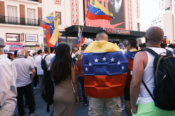 stock image Several people during the demonstration for the mobilization of hope to the caravan of freedom in the upcoming elections in Venezuela, at the Plaza de Espaa, on 21 July, 2024 in Madrid Spain