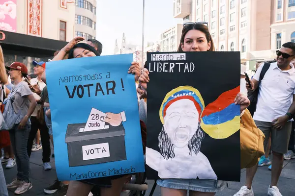 stock image Several people during the demonstration for the mobilization of hope to the caravan of freedom in the upcoming elections in Venezuela, at the Plaza de Espaa, on 21 July, 2024 in Madrid Spain