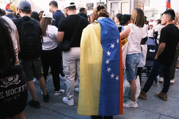 stock image Several people during the demonstration for the mobilization of hope to the caravan of freedom in the upcoming elections in Venezuela, at the Plaza de Espaa, on 21 July, 2024 in Madrid Spain