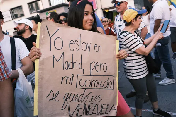 stock image Several people during the demonstration for the mobilization of hope to the caravan of freedom in the upcoming elections in Venezuela, at the Plaza de Espaa, on 21 July, 2024 in Madrid Spain