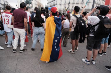 Several people during the demonstration against the results of the Venezuelan elections at sunset on July 29, 2024 in Madrid, Spain clipart