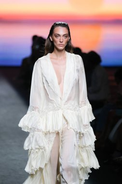 IFERMA 'da Mercedes-Benz Moda Haftası Madrid' de 12 Eylül 2024 'te Odette Alvarez' in tasarladığı tasarımı giyen bir model podyumda yürüyor.