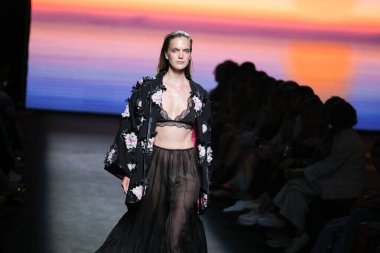 IFERMA 'da Mercedes-Benz Moda Haftası Madrid' de 12 Eylül 2024 'te Odette Alvarez' in tasarladığı tasarımı giyen bir model podyumda yürüyor.