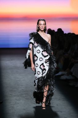 A model walks the runway wearing a design by Odette Alvarez  during Mercedes-Benz Fashion Week de Madrid in IFERMA, September 12, 2024 Spain clipart