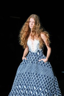 IFERMA 'da Mercedes-Benz Moda Haftası Madrid' de 14 Eylül 2024 'te YOLANCRIS tarafından tasarlanmış bir tasarım giyen bir model podyumda yürüyor.