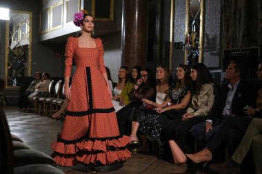 27 Eylül 2024 tarihinde Madrid, İspanya 'da bulunan Wellington Hotel' de düzenlenen Uluslararası Flamenko Moda Haftası Madrid 'de (SIMOF) Moda Flamenka tasarımı içinde yürüyen bir model görülüyor.