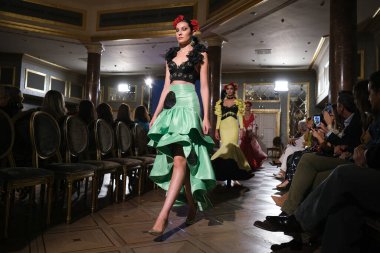27 Eylül 2024 tarihinde Madrid, İspanya 'da bulunan Wellington Hotel' de düzenlenen Uluslararası Flamenko Moda Haftası Madrid 'de (SIMOF) Moda Flamenka tasarımı içinde yürüyen bir model görülüyor.