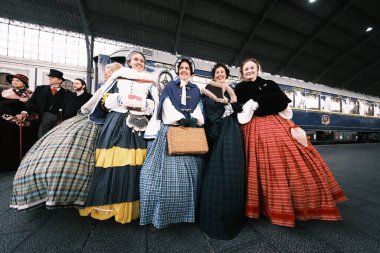 A group of people dressed in 1800 costumes from the Anacrnicos Recreacion Histrica group participate in the 100th anniversary of the Railway Museum madrid 15 December 2024 Spain clipart