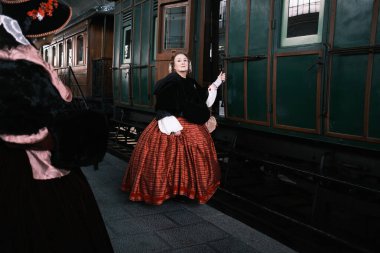 A group of people dressed in 1800 costumes from the Anacrnicos Recreacion Histrica group participate in the 100th anniversary of the Railway Museum madrid 15 December 2024 Spain clipart