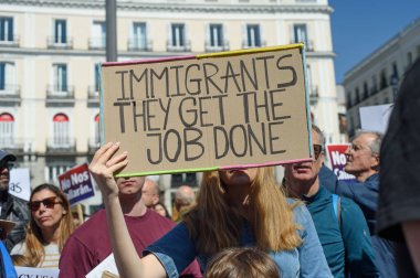 29 Mart 2025 'te Madrid' deki Puerta del Sol 'da düzenlenen Trump karşıtı protesto sırasında bayraklı göstericiler.