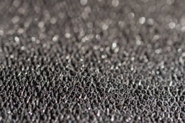 Kısmi bulanık desenli çelik kumaş. Parıltılı arka plan malzemesi. Moda ürünlerinin arka planında kullanılır. Metin için boşluk. 