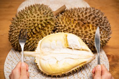 Bıçak ve çatalla Durian ve Eller 