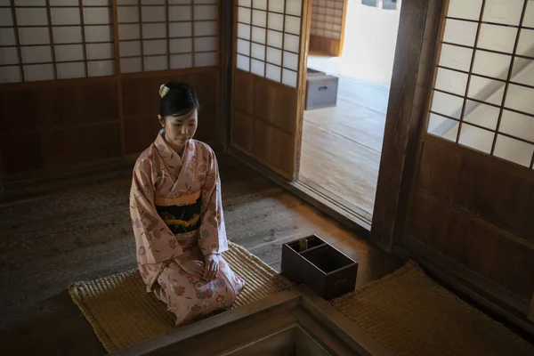Woman wearing a kimono at traditional home