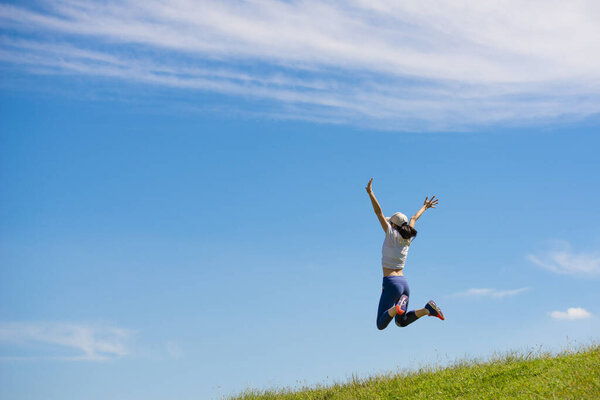 Woman to jump in the meadow