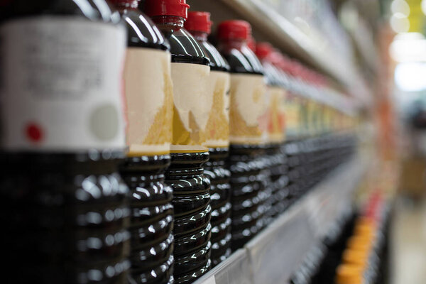 Lots of soy sauce lined up on the shelves