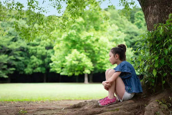 Girl Sitting Shade Tree Stock Image