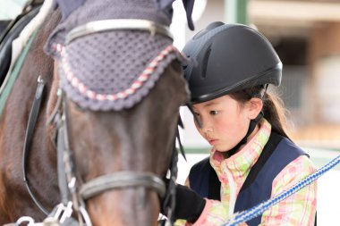 Atla ilgilenen çocuk.